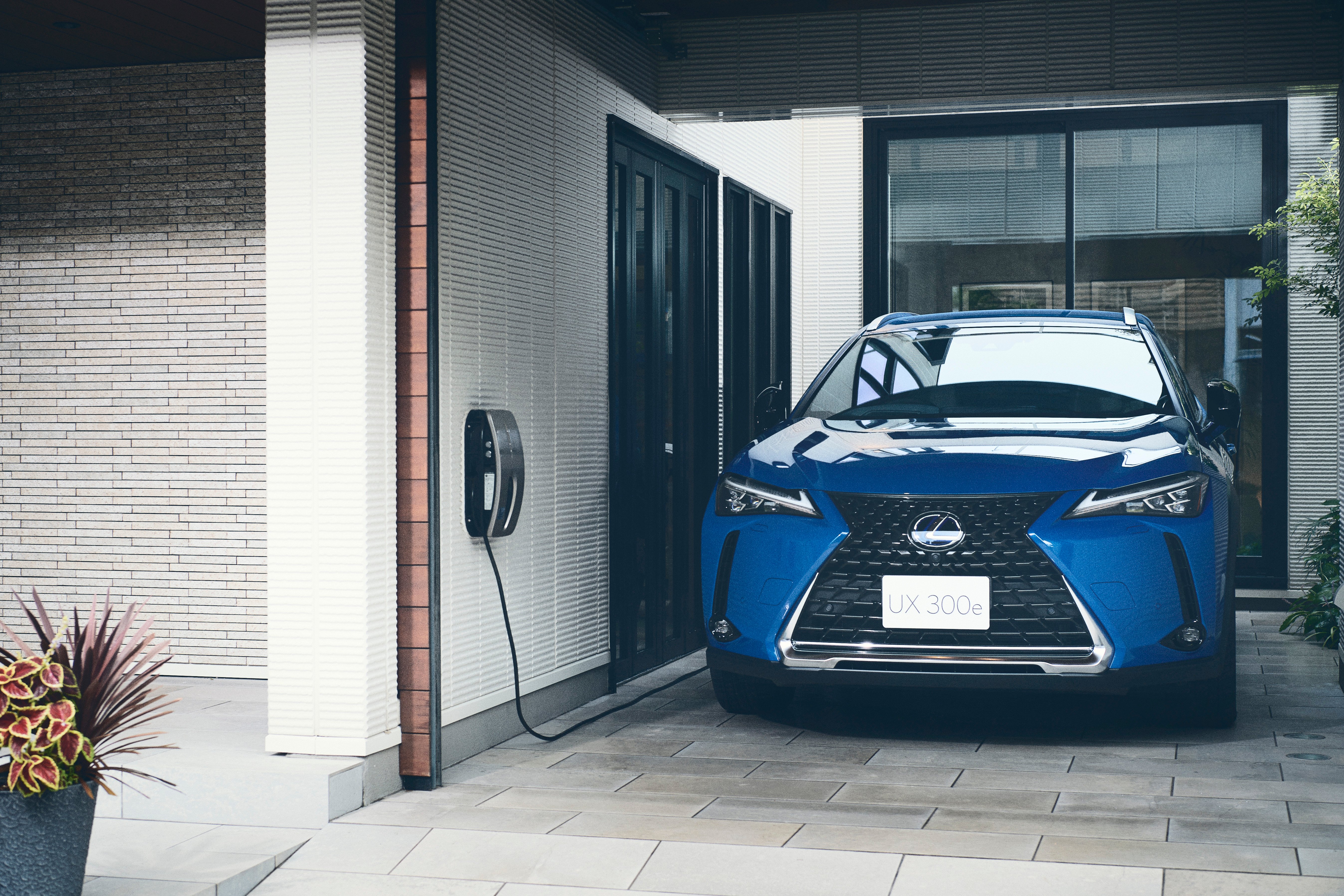 Silver Lexus UX being driven on the road.
