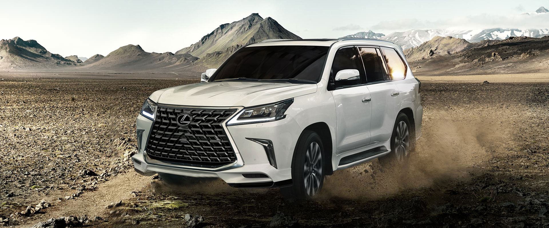 White Lexus LX being driven in sandy terrain.